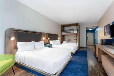 a hotel room with two beds and a television at TRYP by Wyndham Orlando in Orlando