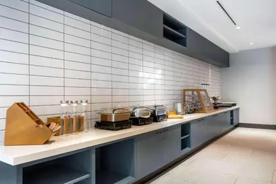 a kitchen with a counter with pots and pans at TRYP by Wyndham Orlando in Orlando