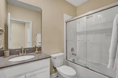a bathroom with a toilet and a sink and a shower at Storey Lake Resort 5 Bedroom Vacation Home with Pool 2307 in Kissimmee