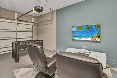 two chairs in a room with a desk and a tv at Storey Lake Resort 5 Bedroom Vacation Home with Pool 2307 in Kissimmee