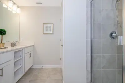 a bathroom with a shower with a glass door at 4731-206OR STOREY LAKE, CONDO 2/2 GARDEN VIEW in Kissimmee