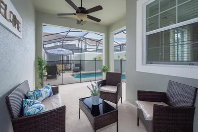 a living room with chairs and a ceiling fan at 4819JA TOWNHOUSE 4 BEDROOMS & 3 BATHROOMS + POOL in Kissimmee