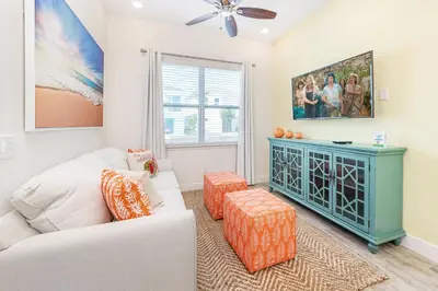 a living room with a white couch and a blue cabinet at Fabulous Cottage Near Disney With Margaritaville Resort & Island H2O Access - 8075Kd in Orlando