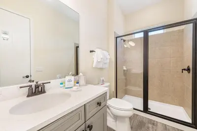 a bathroom with a sink and a toilet and a shower at Celestial Cottage Near Disney With Margaritaville Resort & Island H2O Access - 8036Dr in Orlando