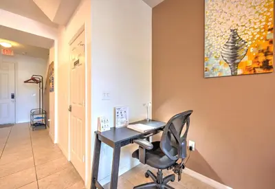 a office with a desk and a chair in a hallway at 4 Bedroom SunHaven Townhouse with Pool Near Disney in Kissimmee