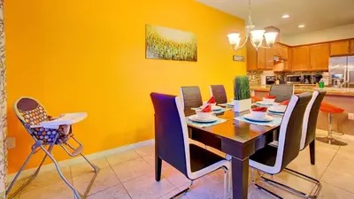 a dining room with a table and chairs at 4 Bedroom SunHaven Townhouse with Pool Near Disney in Kissimmee