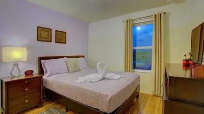 a bedroom with a bed with a swan on it at 4 Bedroom SunHaven Townhouse with Pool Near Disney in Kissimmee