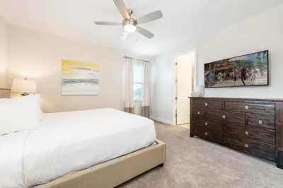 a bedroom with a bed and a ceiling fan at Vibrant Home With Private Pool, Pool Table Near Disney With Waterpark & Resort Access At Encore Resort - 7707Gr in Kissimmee