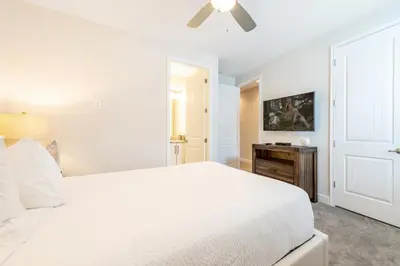 a white bedroom with a bed and a ceiling fan at Vibrant Home With Private Pool, Pool Table Near Disney With Waterpark & Resort Access At Encore Resort - 7707Gr in Kissimmee