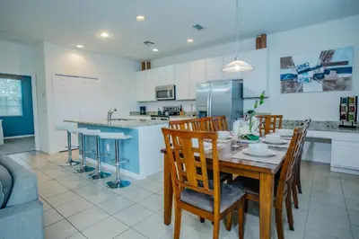 a kitchen and dining room with a table and chairs at Fantastic 4br 3ba with Pvt Pool near to Disney in Kissimmee