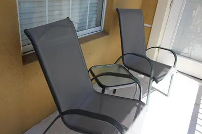 three chairs sitting on a porch next to a window at 205 - Disney, Universal, Convention Center in Orlando