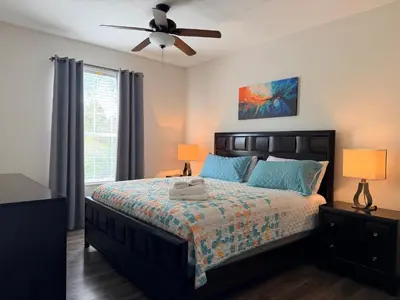a bedroom with a bed and a ceiling fan at 210 Disney Universal Convention Center in Orlando