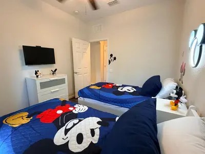 a bedroom with two beds with hello kitty sheets at 210 Disney Universal Convention Center in Orlando