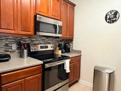 a kitchen with a stove and a microwave at 210 Disney Universal Convention Center in Orlando