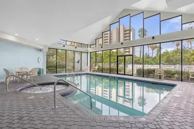 a large swimming pool in a building with windows at 18-Universal and Heart of International Dr in Orlando
