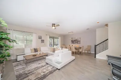 a living room with white furniture and a table at 2705JT LUXURY 7 BED/5 BA (SANITIZED) in Kissimmee