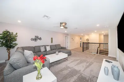 a living room with a couch and a table at 2705JT LUXURY 7 BED/5 BA (SANITIZED) in Kissimmee