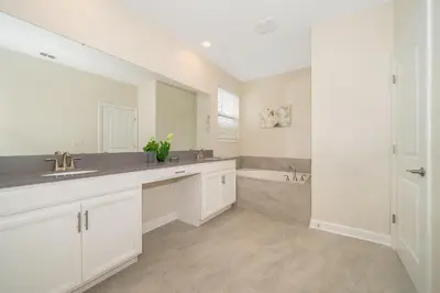 a bathroom with a sink and a tub at 2776LO VILLA 5 BED/5 BA (SANITIZED) in Kissimmee