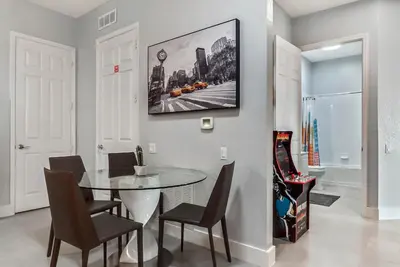 a dining room with a glass table and chairs at Vista Cay in Orlando