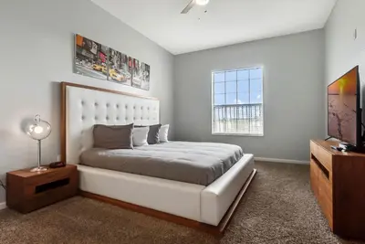 a bedroom with a large white bed and a window at Vista Cay in Orlando