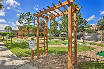 a playground with a wooden pergola in a park at 14 Mi to Disney Parks Spacious Kissimmee Home in Kissimmee
