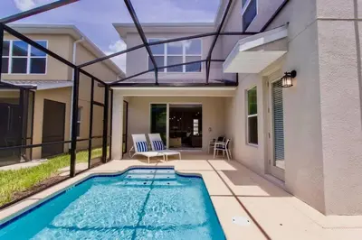 a swimming pool in the backyard of a house at Stunning 5 Bd w/ Pool Close to Disney @ Storey Lake 2767 in Kissimmee