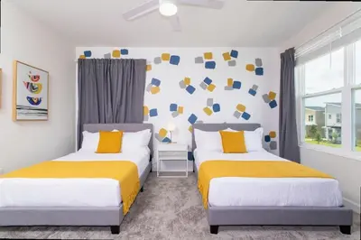 two beds in a room with yellow and white at Stunning 5 Bd w/ Pool Close to Disney @ Storey Lake 2767 in Kissimmee