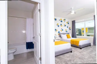 a bedroom with two beds and a bathroom at Stunning 5 Bd w/ Pool Close to Disney @ Storey Lake 2767 in Kissimmee