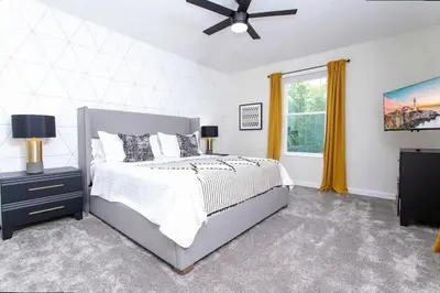 a bedroom with a bed and a ceiling fan at Stunning 5 Bd w/ Pool Close to Disney @ Storey Lake 2767 in Kissimmee
