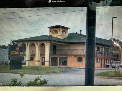 a large building with a clock tower on top of it at REGENCY INN in Orlando