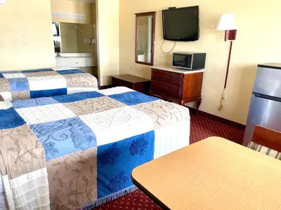 a hotel room with two beds and a tv at REGENCY INN in Orlando