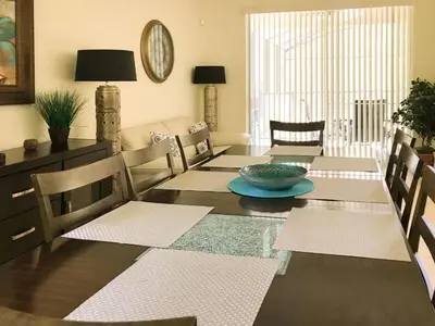 a dining room with a table with a bowl on it at Luxurious With Privacy In 5 Bedroom With Private Pool By Florida Dream Homes in Kissimmee