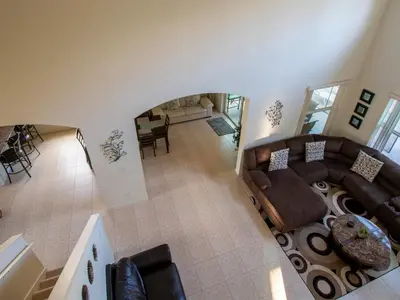 an overhead view of a living room with a couch at Luxurious With Privacy In 5 Bedroom With Private Pool By Florida Dream Homes in Kissimmee