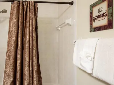 a shower with a shower curtain in a bathroom at Luxurious With Privacy In 5 Bedroom With Private Pool By Florida Dream Homes in Kissimmee