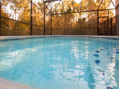 a large swimming pool with blue water at Luxurious With Privacy In 5 Bedroom With Private Pool By Florida Dream Homes in Kissimmee