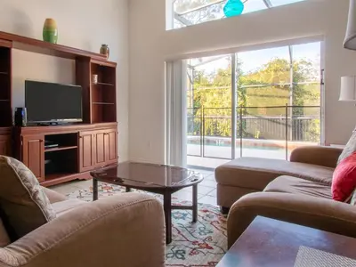 a living room with two couches and a tv at 4 Bed And 3 Bath In Perfect Location With Pool By Florida Dream Home in Kissimmee