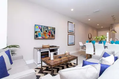 a living room with white chairs and a table at Gorgeous 4 Bedroom Family Friendly Close to Disney 7573 in Orlando