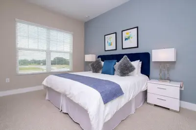 a bedroom with a large bed and a window at Gorgeous 4 Bedroom Family Friendly Close to Disney 7573 in Orlando