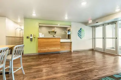 a large room with a table and chairs in it at WoodSpring Suites Sanford North I-4 Orlando Area in Sanford