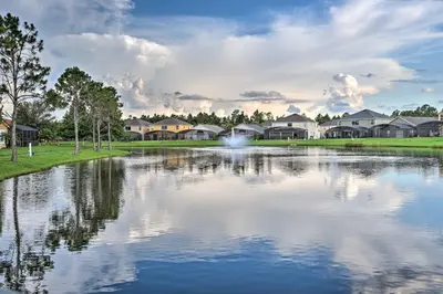 a view of a lake with houses in the background at 8 Mi to Disney Villa with Screened Pool and Lanai in Kissimmee