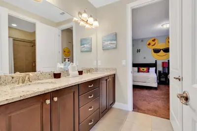 a bathroom with a sink and a large mirror at 491 Lasso dr in Orlando