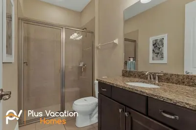 a bathroom with a shower and a toilet and a sink at 7617 Brookhurst lane in Orlando