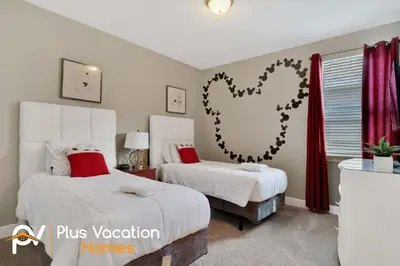two beds in a bedroom with red curtains at 7617 Brookhurst lane in Orlando