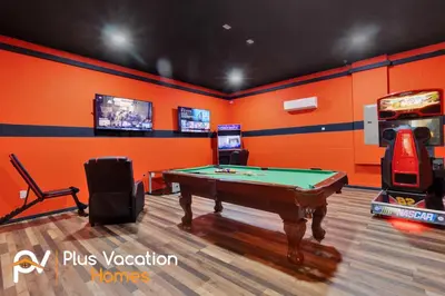 a room with a pool table and a video game at 7617 Brookhurst lane in Orlando