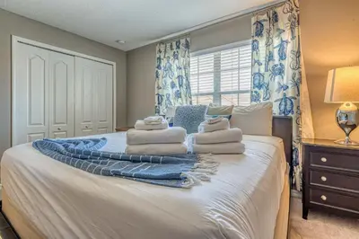 a bedroom with a bed with towels on it at Resort Retreat in Kissimmee