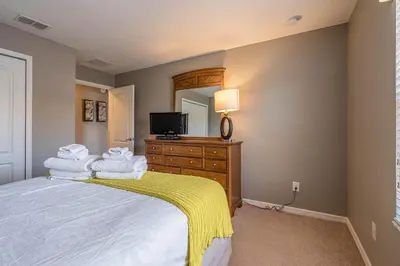 a bedroom with a bed and a tv on a dresser at Resort Retreat in Kissimmee