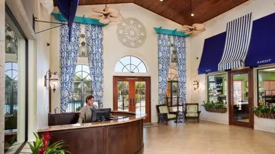 a man sitting at a bar in a lobby at Resort Retreat in Kissimmee