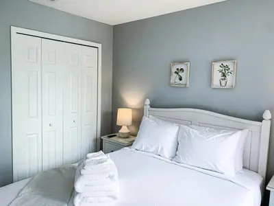 a bedroom with a bed with white pillows at Crystal Villa in Kissimmee