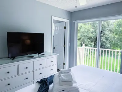 a bedroom with a tv and a bed with a dresser at Crystal Villa in Kissimmee