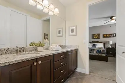 a bathroom with a sink and a large mirror at 551 Villa 8BD PoolSpa - Game room Movie room in Orlando
